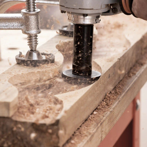 Heavy Duty Mini Turbo Angle Grinder Kit With 50 Millimeter Tungsten Cutters in action, carving wood with precision and producing shavings.