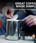Person placing a paper disc filter into a percolator for brewing. Premium Disc Percolator Coffee Filters For Campers And Home Brewers fit.