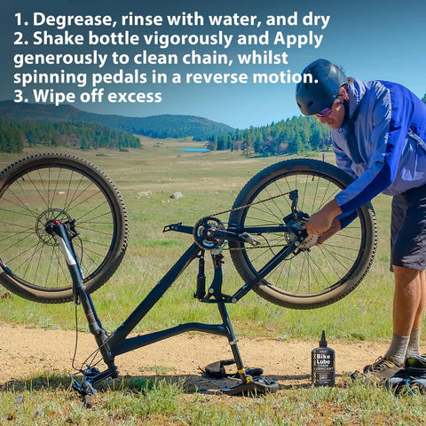 Cyclist applying No Nonsense Dry Bike Chain Lube For MTB With Ceramic Coating And PTFE to a mountain bike in a scenic outdoor setting