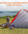 Camping scene with Go To All In One Portable Power Station, 100W solar generator and foldable 40W panel next to a tent by a lake.
