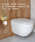 Toilet Paper Holder With Shelf Wall Mount In Gold For Modern Bathrooms next to a toilet, holding wipes and toilet paper