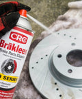 CRC Brakleen brake parts cleaner spray can, Pro Series, 29 oz, non-flammable, held by gloved hand beside a brake rotor.