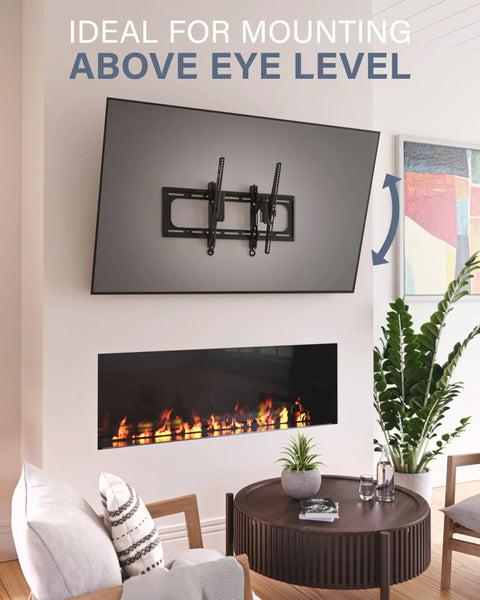 Heavy Duty Tilting TV Wall Mount For Big Screens Up To 90 Inches And 150 Pounds mounted above a modern fireplace in a living room.
