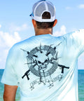 Skull and Speargun Spearfishing Tee for Men in Light Blue, back view with scuba diving design, worn by man at beach