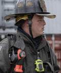 Firefighter wearing gear with Survivor 175-Lumen Rechargeable Firefighter Right Angle Flashlight Intrinsically Safe Safety-Rated Orange
