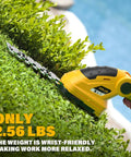 Using Cordless Hedge Trimmer And Grass Shears 2 In 1 Electric Handheld Shrub Trimmer on a green hedge