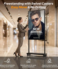 Straight Fire 65 Inch Storefront Digital Signage Display in a freestanding setup with woman adjusting the screen.