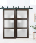 Lucia 2552 Interior Barn Bypass Sliding Doors with frosted glass and solid wood, black finish, modern style, installed view