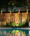 Bamboo Tiki Torches Outdoor Mosquito Repellent 12 Pack, 60 Inch Tall Garden And Backyard Lights by a pool; citronella oil lamps.