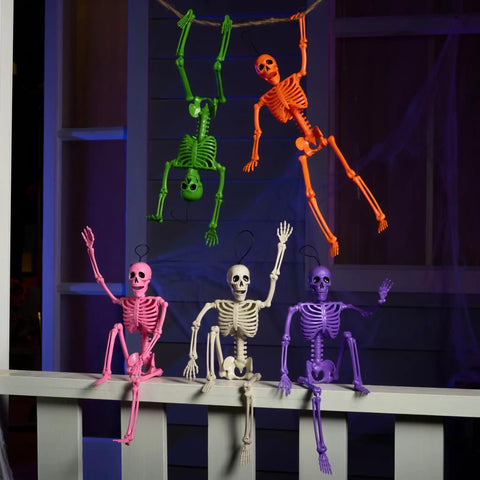 Spooky Hanging 16 Inch Posable Skeleton Set for Halloween Decor in various colors on porch rail and hanging from rope.
