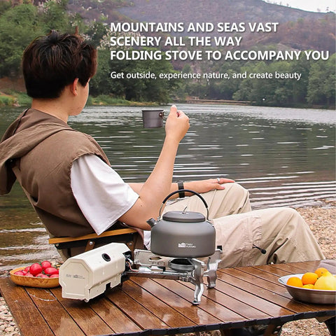 Person camping by a lake with 2600W Portable Gas Stove With Cassette Design And Multi Stage Adjustable Flame for cooking outdoors