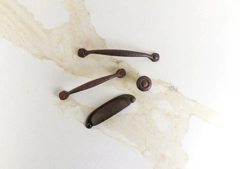Solid Core Cabinet Pulls Set of 10 in Rustic Iron with 3 inch center to center on marble background