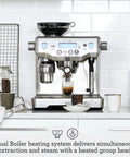 Oracle Fully Automatic Espresso Machine In Brushed Stainless Steel With 58 mm Portafilter Integrated Grinder And Slick Milk Frother on kitchen countertop.