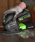 Cordless Detail Sander Kit With 20V Battery And Charger Included being used on wood surface, showing dust collection system.