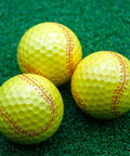 Yellow Softball Print Novelty Golf Balls 12 Pack For Players And Coaches And Sports Fans Perfect Gift For Tournaments And League Play Stand Out On The Course With 360 Degree Softball Design, featuring three golf balls with softball print on grass.