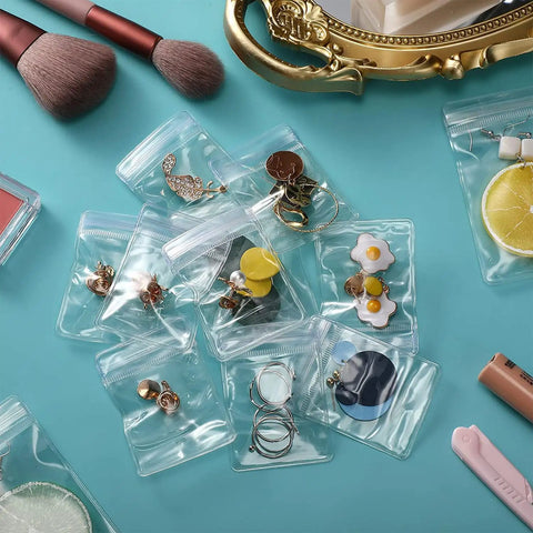 Clear Jewelry Zipper Bags For Packaging Rings And Earrings, Anti Tarnish And Waterproof, Transparent Poly Pouches, 2.75 By 4 Inches, 100 Pack, with earrings and rings displayed