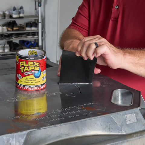 Heavy Duty Rubberized Waterproof Tape For Patching Leaks And Sealing Repairs That Works Underwater, Tough As Nails For Indoor And Outdoor Use On Home RV Roof Plumbing And Pool Projects, Black 4 In By 5 Ft Pack Of 1 being applied to metal