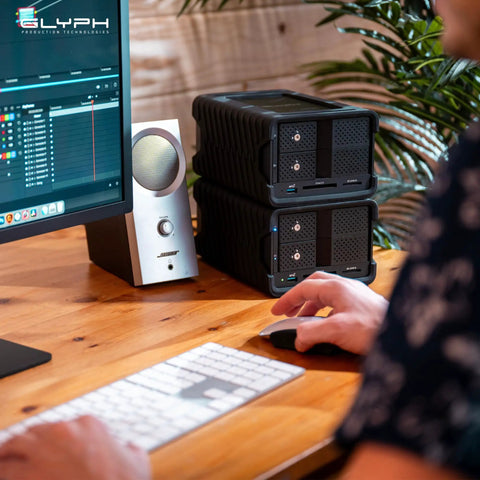 Heavy Duty 48TB Thunderbolt Three Desktop Raid Storage Array With Enterprise 7200RPM Drives, dual units beside a monitor.