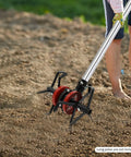 Six Claw Deep Plow Cultivator Wheel Attachment in use on soil, connected to lawn care tool, demonstrating weed-busting capability.