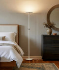 Sky LED Floor Lamp Torchiere Lit And Super Bright Dimmable Tall Standing Lamp next to bedroom furniture.