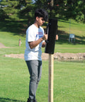 Person using Beefy Post Driver And Rammer For Fence Installations Heavy Duty 30 Lb Tool 24 Inch Tall with 13 Inch Wide Grip
