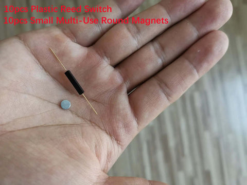 10 Pack Plastic Reed Switches No Magnetic Induction Sensor with Small Round Magnets in a person's hand.
