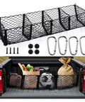 Multi Compartment Truck Bed Cargo Net For Tesla Cybertruck 2024 with groceries and gear secured in truck bed.