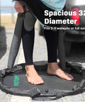 Person using Wetsuit Changing Mat And 2 In 1 Gear Bag With 5000X Waterproof Tech, 32-inch diameter, on a paved surface
