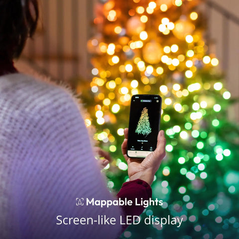 Person using app to control 105 Foot Smart String LED Lights with 400 RGB White LEDs on Christmas tree, WiFi and Bluetooth.