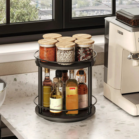No Fuss Dual Tier Lazy Susan Turntable Gliding On Slick Ball Bearings, Compact Black Spice Rack Organizer For Kitchen Counters And Cabinets, 360 Degree Spinner Tray with spice jars and oils on display.