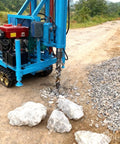 No Fuss Mini Hydraulic Water Well Drilling Rig 200 Meter Deep Borehole Drill drilling into rocky ground on a job site.