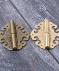 Sick Antique Brass Flower Hinge Pair Decorative Cloud Hinge For Cabinet Drawer And Jewelry Box Includes Heavy Duty Screws For A Top Shelf Furniture Hardware Upgrade 60 By 55 Mm on wooden surface.