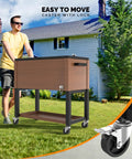 Man pushing 80 Quart Rolling Ice Chest On Wheels Cooler Cart With Cover And Drain Hose for Patio Pool Parties, wood color.