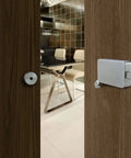 Surface Jamb Mount Door Lock For Barn And Interior Doors on wooden door, privacy hardware in graphite black finish, office setting