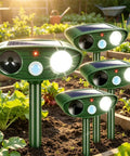 4 Pack Solar Ultrasonic Animal Deterrents With PIR Motion Sensor, waterproof green stake units in a garden bed