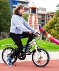 Child riding a bicycle equipped with Totally Sick Spider Bike Wheel Spoke Lights LED Glow For Night Rides, Waterproof Motion Activated Spoke Lights For Kids.