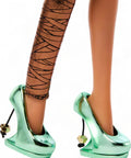 Cleo De Nile Fashion Figure Featuring A Chic Asymmetric Wrap Dress And Bold Over The Shoulder Neckline Perfect For Nightclub Parties showcasing green emerald pumps and metallic bandage tights.