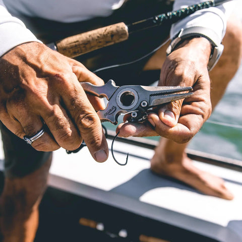 Man using Titanium Fishing Pliers with Side Cutters, Halo Hinge, Lanyard, Leather Sheath, Saltwater Ready on boat