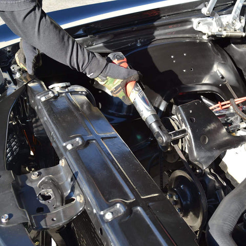 Mechanic using Workhorse 12V Cordless Ratchet Wrench Kit With Three Eighths Inch Drive 57 Ft Lbs Torque Li Ion Power Includes Two Batteries And Carrying Case Lightweight Auto And Diy Repair Tool in engine bay