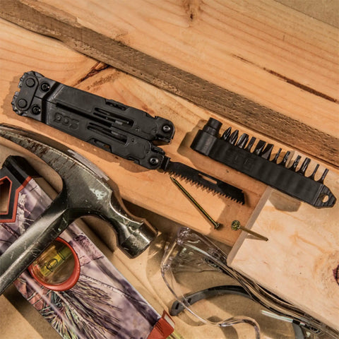 PowerAccess Deluxe All Purpose Heavy Duty Stainless Steel Multi Tool with bits and wood saw on a workshop surface.