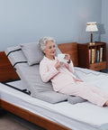 Sturdy Greenlemon Electric Bed Backrest Lifter With Remote Adjustable Support For Heavy Duty Use Up To 300 Pounds Load Capacity Flexible Angle Settings From Four To Sixty Eight Degrees Perfect For Relaxing Or Reading with a woman enjoying tea.