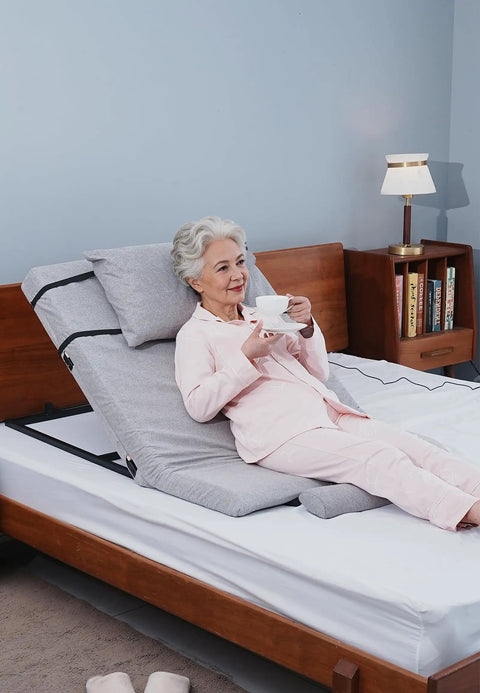 Sturdy Greenlemon Electric Bed Backrest Lifter With Remote Adjustable Support For Heavy Duty Use Up To 300 Pounds Load Capacity Flexible Angle Settings From Four To Sixty Eight Degrees Perfect For Relaxing Or Reading with a woman enjoying tea.