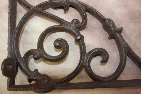 Close-up of a Heavy Duty Victorian Corner Shelf Bracket showing intricate swirl design in solid cast iron rustic brown finish.
