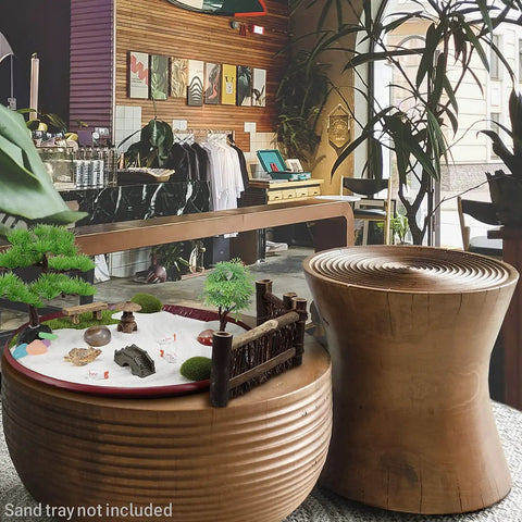 Desktop Zen Garden Kit For Your Desk Or Office, DIY Zen Garden Set With sand, rocks, rake, trees on round wooden table in store.