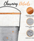 Close-up of galvanized metal bucket with wooden handle, displaying embossed details and rings, highlighting the craftsmanship.
