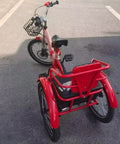 Red folding tricycle with rear passenger seat in PU leather, adjustable height, dual brakes, and pneumatic spoke wheels.