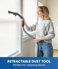 User using the retractable dust tool of a Quiet Bagless Canister Vacuum With Kickass Suction For Whole Home Cleaning.