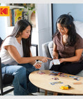 Two women using Step Instant Smartphone Photo Printer On The Go Portable Mini Color Wireless Printer for iOS and Android.