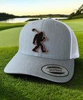 Bigfoot Patch Golf Hat With Sasquatch Holding A Golf Club Heather White Trucker Snapback For Men And Women on golf course