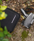 6000 Lumen Waterproof Marine Spotlight With Rechargeable LED Battery next to EVA carrying case on a leafy ground